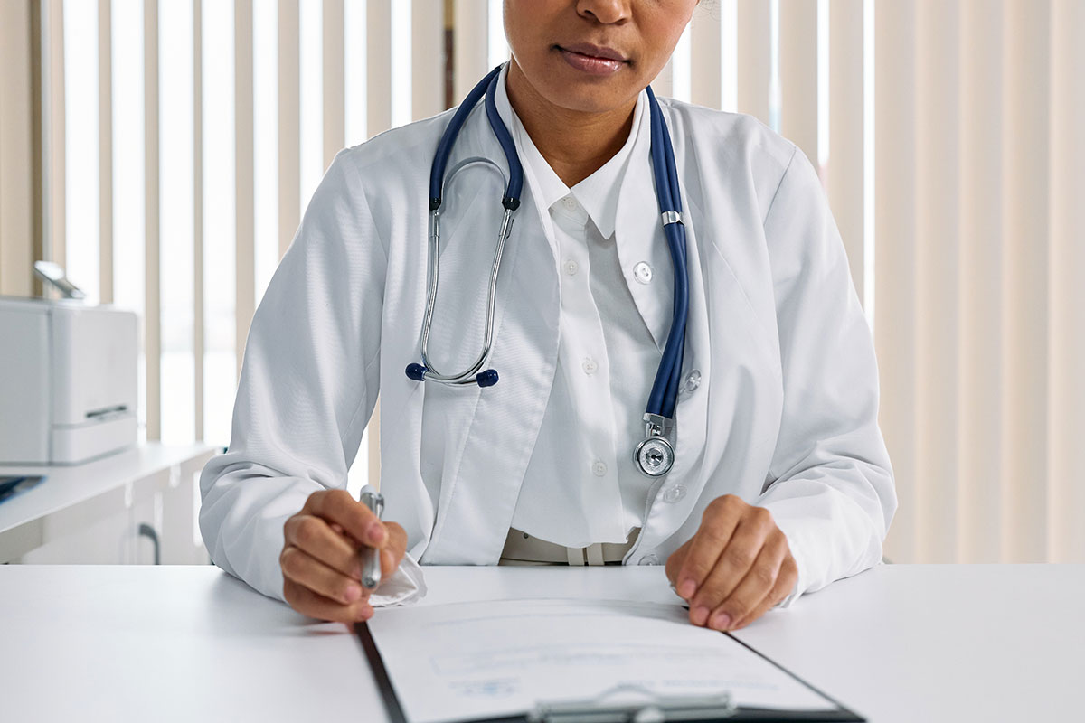 female afro-american doctor in white robe with a prescription